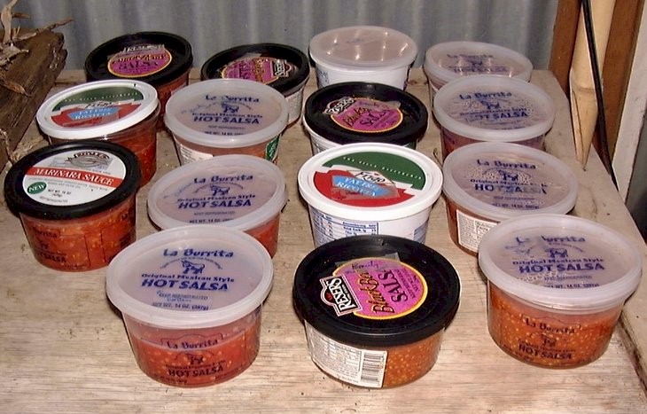 Containers of fermenting tomato seeds.